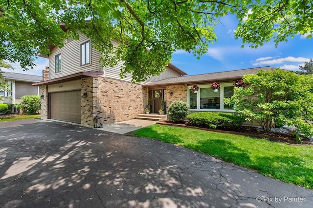 6561 Dunham Rd, Downers Grove, IL 60515 - split level home featuring asphalt driveway, brick siding, and an attached garage