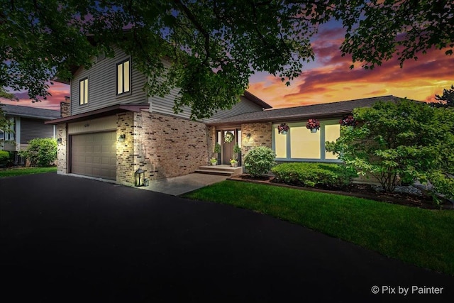 6561 Dunham Rd, Downers Grove, IL 60515 - view of front of property featuring brick siding, a garage, and driveway