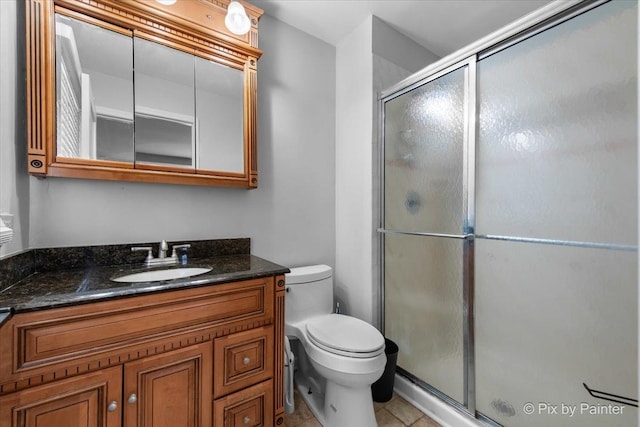 6561 Dunham Rd, Downers Grove, IL 60515 - bathroom featuring toilet, vanity, a shower stall, and tile patterned flooring