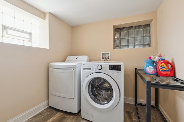 laundry area with baseboards, laundry area, wood finished floors, and washer and dryer