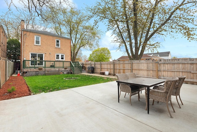 view of patio with a deck, outdoor dining area, and a fenced backyard