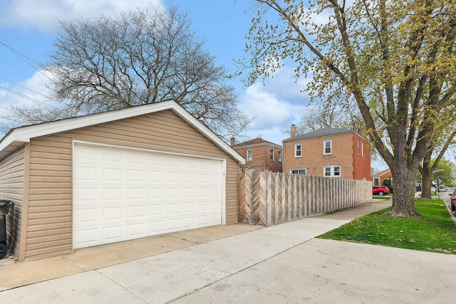 detached garage featuring fence