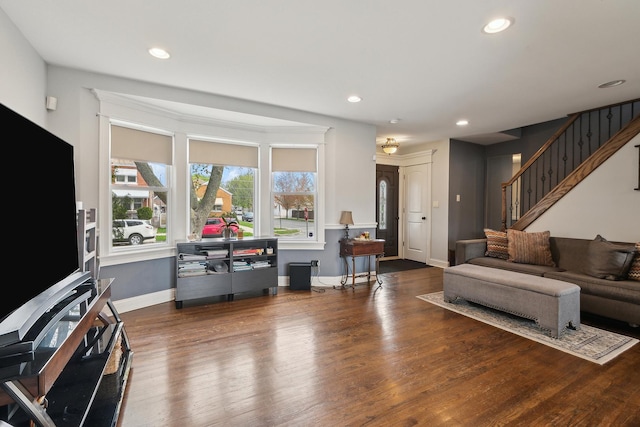 living room with recessed lighting, wood finished floors, and stairway