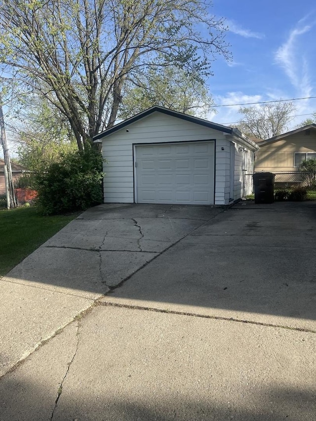 detached garage featuring concrete driveway