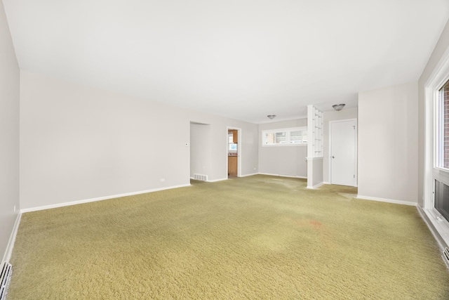 unfurnished living room featuring baseboards, light colored carpet, and visible vents