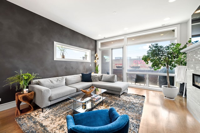 2424 W Chicago Ave Unit 203, Chicago, IL 60622 - living room with recessed lighting, wood finished floors, an accent wall, and a high end fireplace