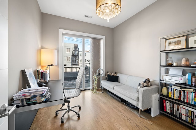2424 W Chicago Ave Unit 203, Chicago, IL 60622 - office space with a chandelier, wood finished floors, and visible vents