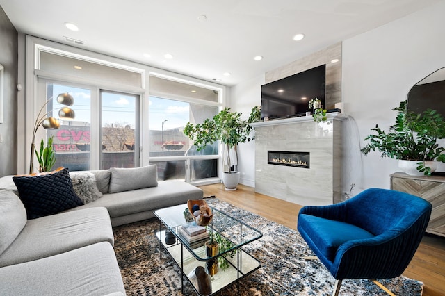2424 W Chicago Ave Unit 203, Chicago, IL 60622 - living area with recessed lighting, wood finished floors, visible vents, and a tile fireplace