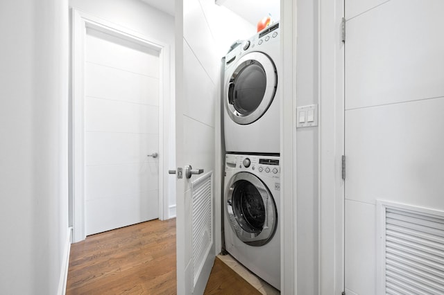 2424 W Chicago Ave Unit 203, Chicago, IL 60622 - washroom with stacked washing maching and dryer, laundry area, and wood finished floors