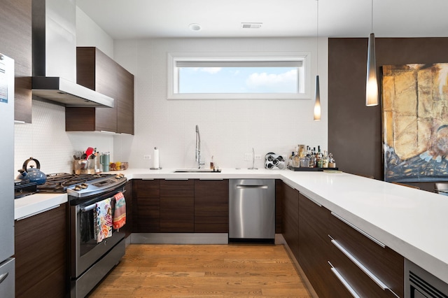 2424 W Chicago Ave Unit 203, Chicago, IL 60622 - kitchen featuring modern cabinets, wall chimney range hood, a sink, appliances with stainless steel finishes, and backsplash