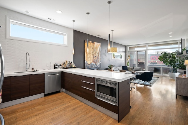 2424 W Chicago Ave Unit 203, Chicago, IL 60622 - kitchen featuring appliances with stainless steel finishes, a sink, light countertops, open floor plan, and modern cabinets