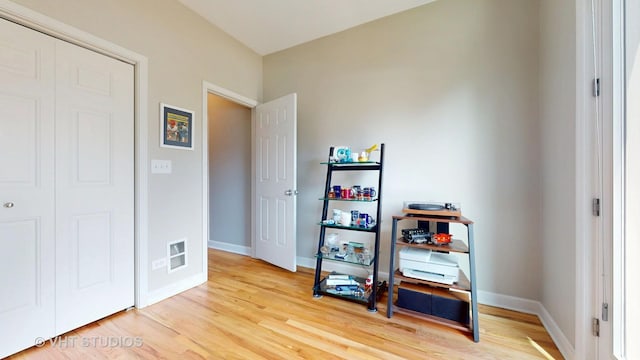 misc room with light wood-style flooring and baseboards
