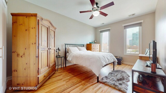 bedroom featuring light wood-style floors and baseboards