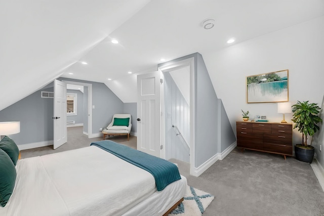 bedroom featuring light colored carpet, baseboards, visible vents, and vaulted ceiling