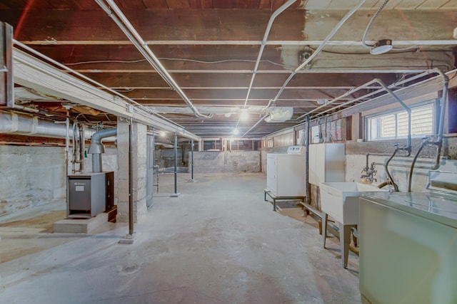 basement featuring a sink and washing machine and dryer