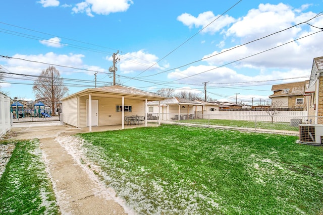 back of house featuring a lawn, a patio, cooling unit, and fence