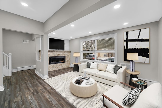 living room with visible vents, a baseboard radiator, wood finished floors, and recessed lighting
