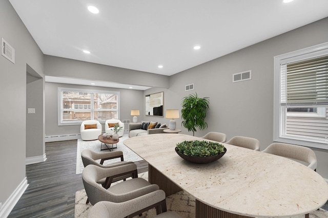 dining space with recessed lighting, baseboard heating, dark wood-style flooring, and visible vents