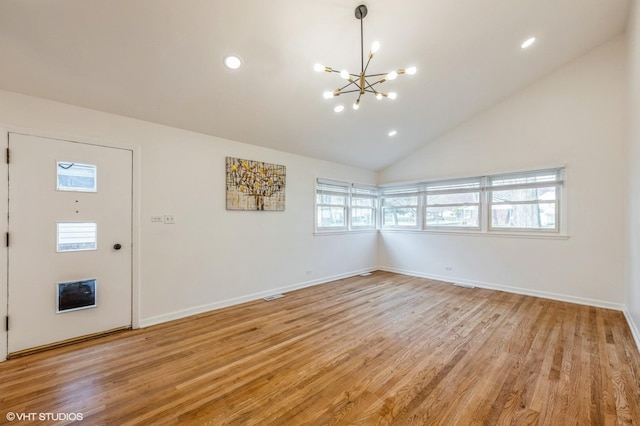 foyer featuring baseboards, recessed lighting, light wood-style flooring, and a notable chandelier