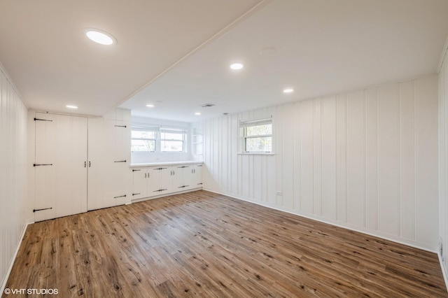 below grade area with recessed lighting, wood finished floors, and visible vents