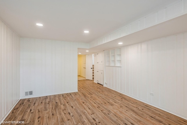 spare room featuring visible vents, recessed lighting, and wood finished floors