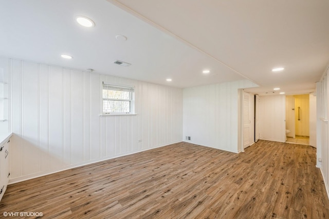 below grade area featuring recessed lighting, wood finished floors, and visible vents