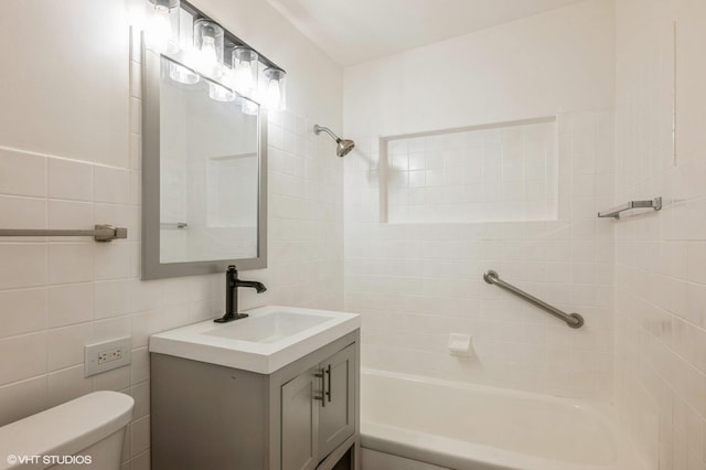 bathroom with vanity, shower / bathing tub combination, toilet, and tile walls