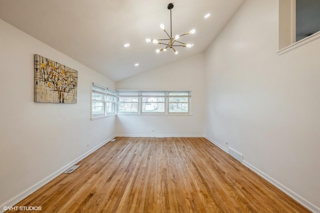 unfurnished room featuring light wood-style floors, baseboards, a notable chandelier, and visible vents