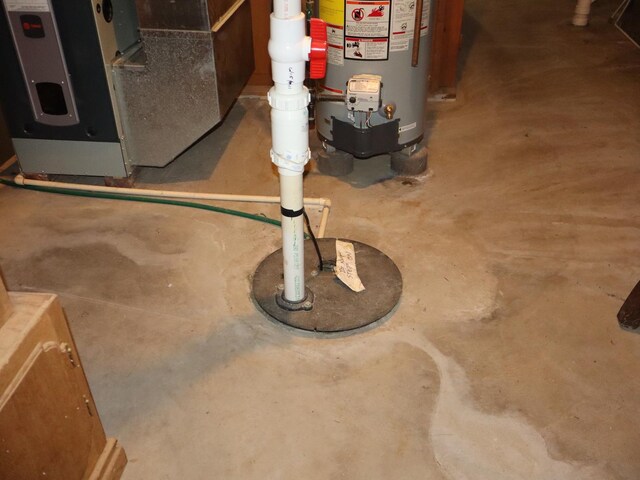 1605 Sharon Rd, Streator, IL 61364 - details featuring concrete flooring, gas water heater, and drainage system