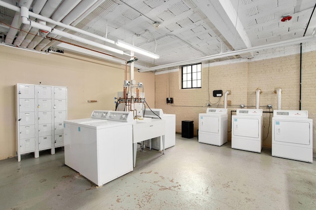 washroom with washing machine and clothes dryer and a sink