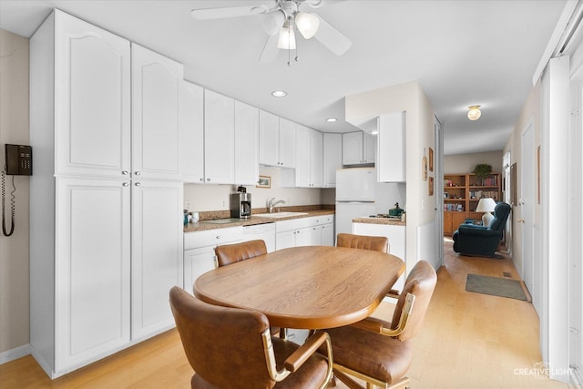 dining space featuring a ceiling fan, baseboards, recessed lighting, and light wood-type flooring