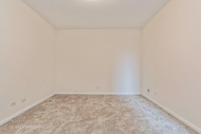 carpeted spare room with baseboards
