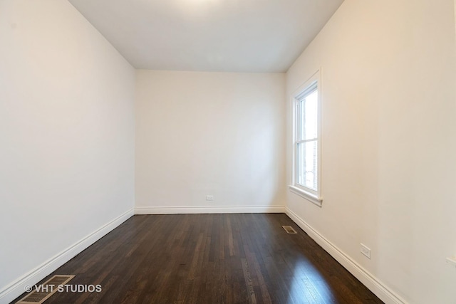 7946 S Aberdeen St, Chicago, IL 60620 - empty room featuring dark wood-style flooring, baseboards, and visible vents