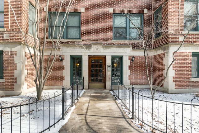 5545 S Kimbark Ave Unit 3, Chicago, IL 60637 - snow covered property entrance featuring brick siding and fence