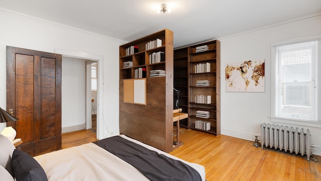 5545 S Kimbark Ave Unit 3, Chicago, IL 60637 - bedroom featuring radiator heating unit, baseboards, crown molding, and light wood finished floors