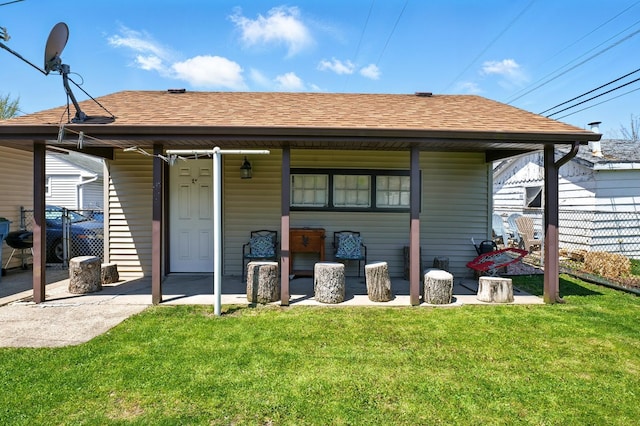 8801 S Kilbourn Ave, Hometown, IL 60456 - rear view of property featuring roof with shingles, fence, a yard, and covered porch