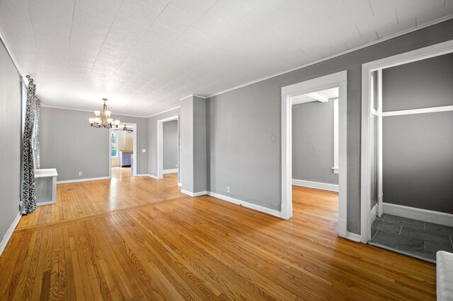 809 W Touhy Ave, Park Ridge, IL 60068 - interior space featuring an inviting chandelier, baseboards, crown molding, and light wood-style flooring