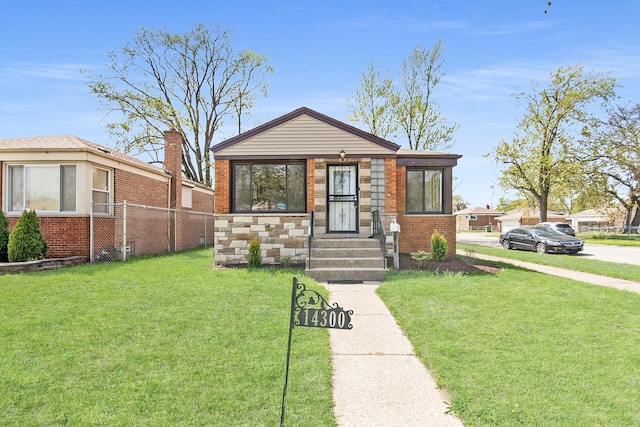bungalow-style home featuring brick siding, fence, and a front lawn