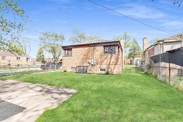 rear view of house featuring brick siding, a fenced backyard, a lawn, and central air condition unit