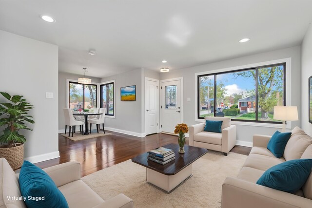 living area with baseboards, recessed lighting, and wood finished floors