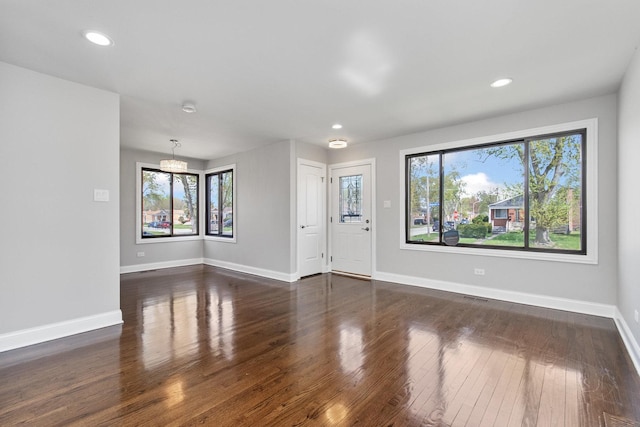 unfurnished living room with baseboards, recessed lighting, dark wood-style floors, and visible vents