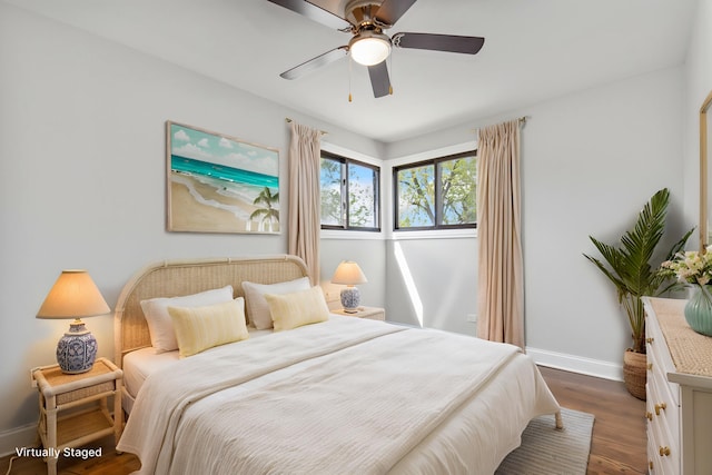 bedroom with dark wood-style flooring, baseboards, and a ceiling fan