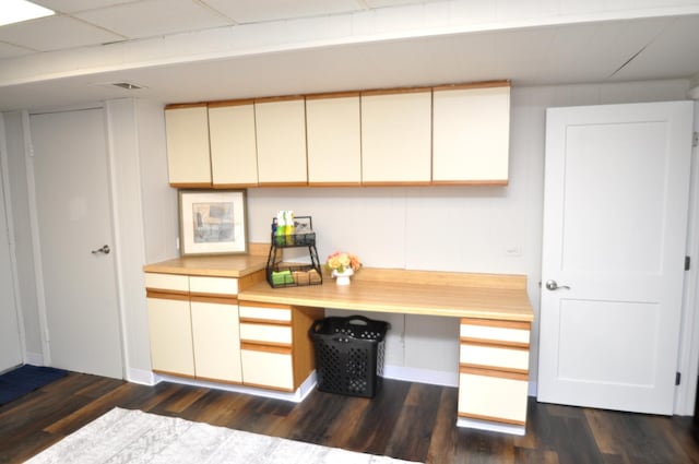kitchen featuring baseboards, light countertops, and dark wood-style floors