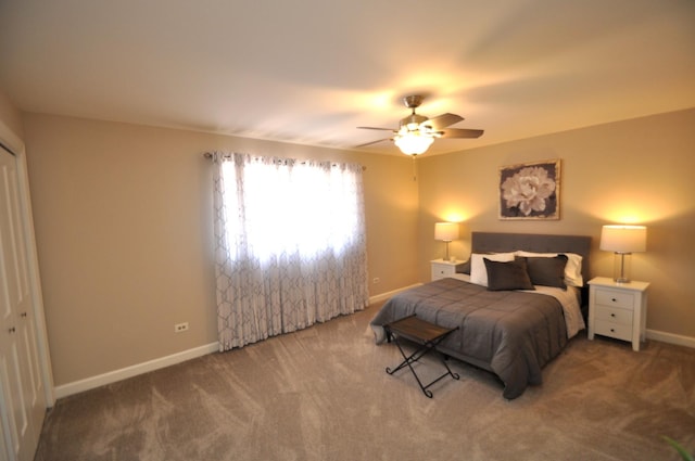 carpeted bedroom featuring baseboards and ceiling fan