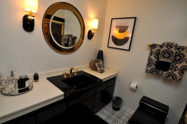 bathroom featuring a sink, baseboards, and tile patterned flooring