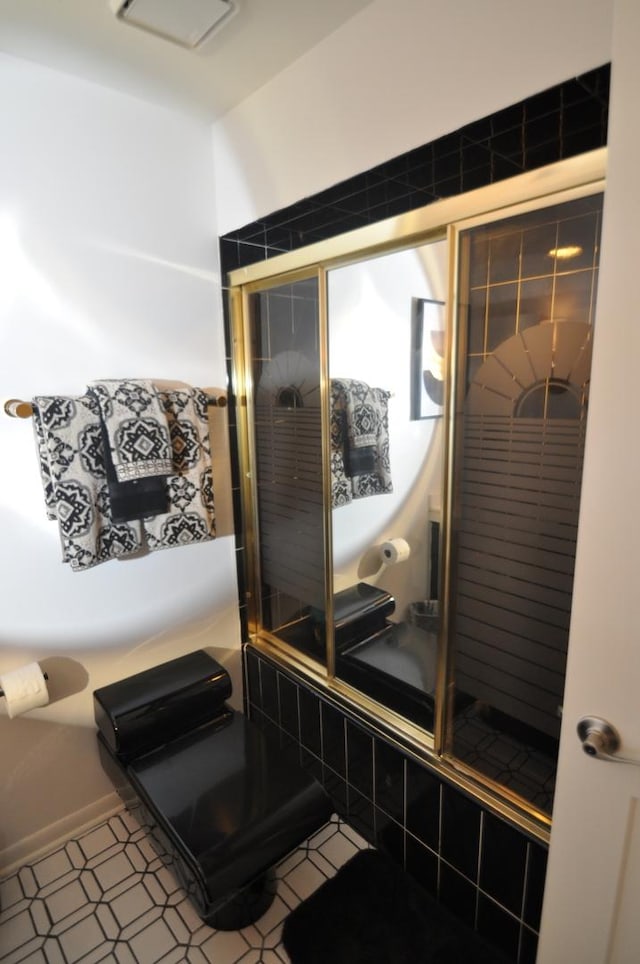 bathroom with tile patterned floors and a tile shower