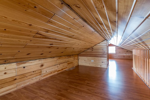 additional living space featuring wood walls, wood ceiling, wood finished floors, and vaulted ceiling