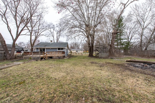 view of yard featuring fence and a deck