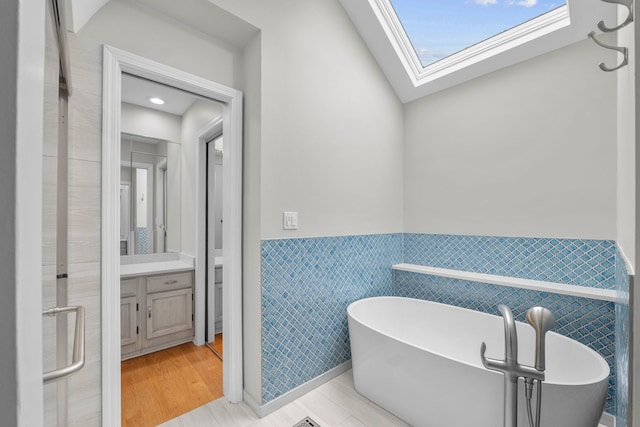 3130 Kayjay Dr, Northbrook, IL 60062 - full bathroom featuring vanity, tile walls, a soaking tub, and a wainscoted wall