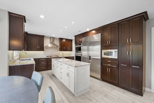 3130 Kayjay Dr, Northbrook, IL 60062 - kitchen with a sink, built in appliances, tasteful backsplash, light stone counters, and wall chimney exhaust hood